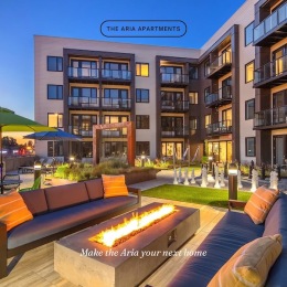 a courtyard with a fire pit and couches