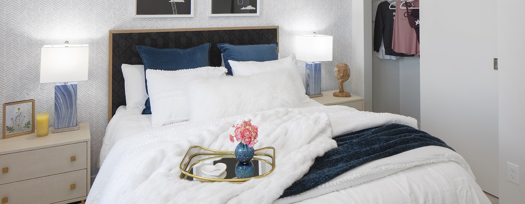 a bedroom with a bed and lamps