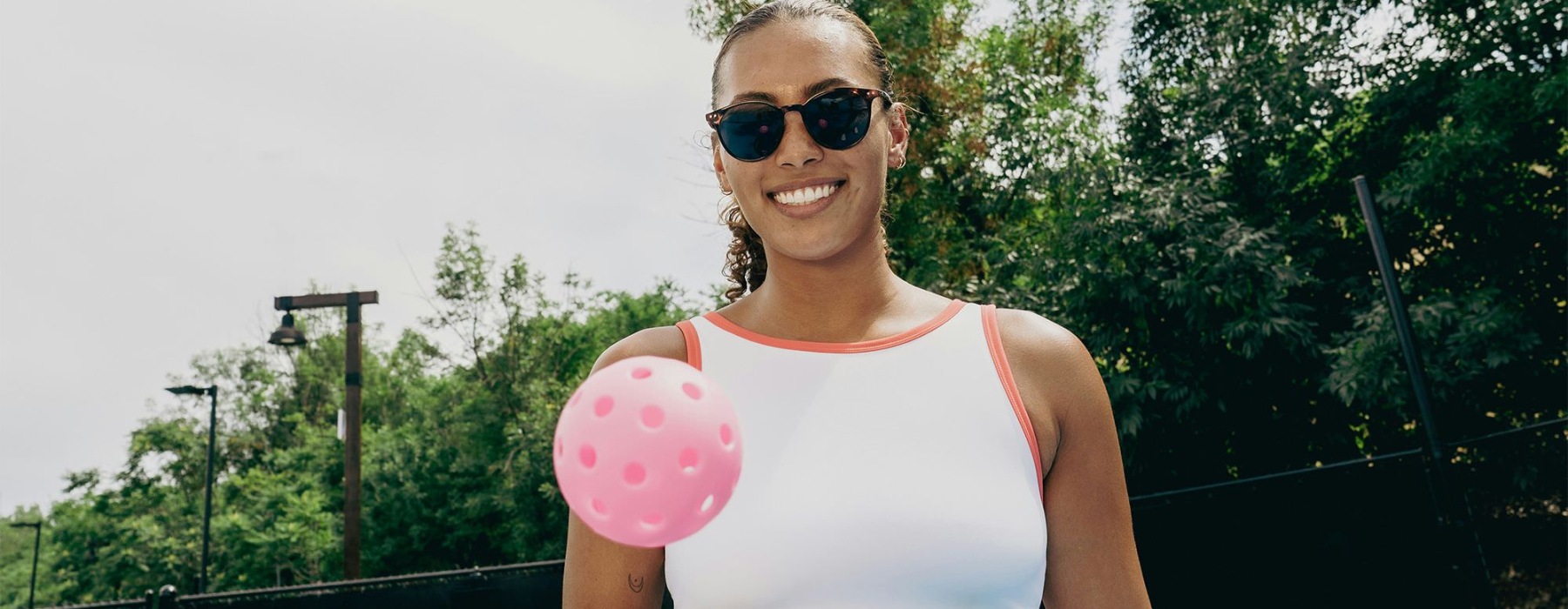 a woman holding a paddle and a ball