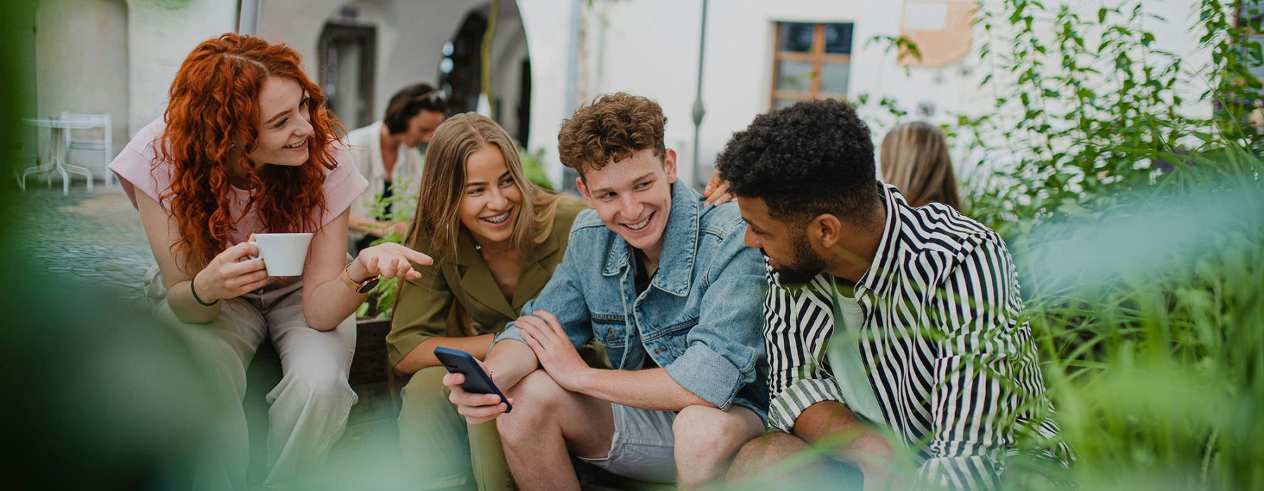 A group of people sitting with each other.